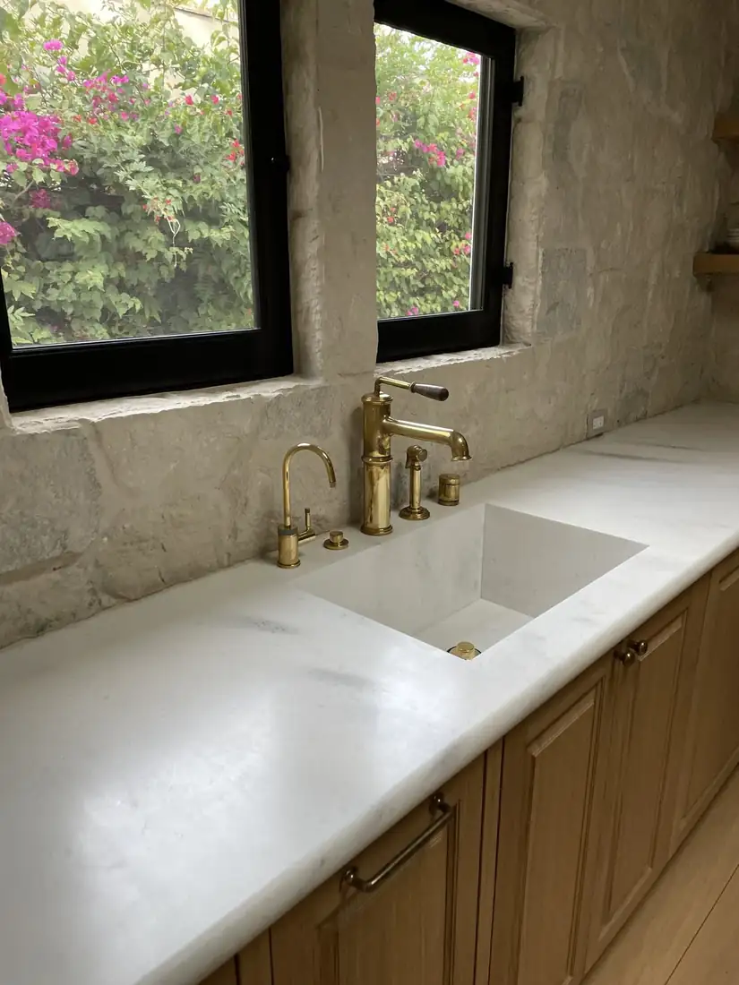 Stone wall, integrated marble sink, brass